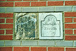 Christchurch 4 and St. John the Baptist 29 markers. They have been reeset into a modern building, Tower Lane