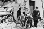 Ratings from HMS Wrangler digging for a trapped family in the village of Samos, August 1953. Image from Imperial War Museums, A32635