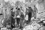 Royal Marines stretcher out an injured victim of the earthquake, August 1953. Image from Imperial War Museums, A32664
