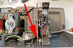 The spring steel part is difficult to see but it is behind the lamp holder. On the left, it rests against the lamp holder platform, sometimes in a small groove, and on the right in a notch in the cam at the bottom of the on/off shaft.