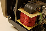 When working on this area of the projector, it is easiest to remove the front cover. The cover is held in place with three bolts. This is the left bolt when looking at the back of the projector.