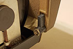 When working on this area of the projector, it is easiest to remove the front cover. The cover is held in place with three bolts. This is the right bolt when looking at the back of the projector.
