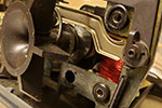 The motor is held on to the backing plate by three bolts. Each passes through a rubber grommet and a metal bushing. Here, the top 3/8" grommet is the original, the right-hand lower grommet has been replaced and the left-hand lower grommet has been removed ready for cleaning and replacement. The original metal bushings were kept and reused.
