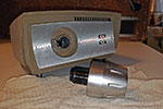 Start by unscrewing the lens body and zoom shroud anticlockwise from the projector. It will take at least 8 turns of the zoom shroud to completely unscrew the lens from the body and then it can be simply be pulled out.