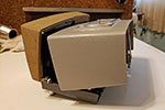 Pull of the cover of the projector backwards and upwards to remove it.