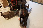 Remove the screws holding the mechanism in the projector.