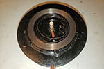 Under the larger cover is the other main electrical terminal and the spring steel that provides the tension for the self-winding mechanism.