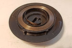 Should the spring steel fall out or become dislodged, the easiest method to put it back is to place the outside loop over the post provided for it and feed the rest of the spring from the outside in.